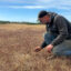 Seth Kroeck points out new spring growth in his wild blueberry fields at Crystal Spring Farm in Brunswick, Maine. Credit: Sydney Cromwell/Inside Climate News