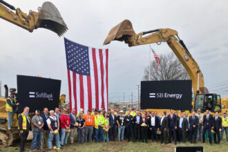 Officials and local workers pose for photos following the ceremonial groundbreaking for SoftBank’s PORTS Technology Campus near Piketon, Ohio. Credit: Dan Gearino/Inside Climate News