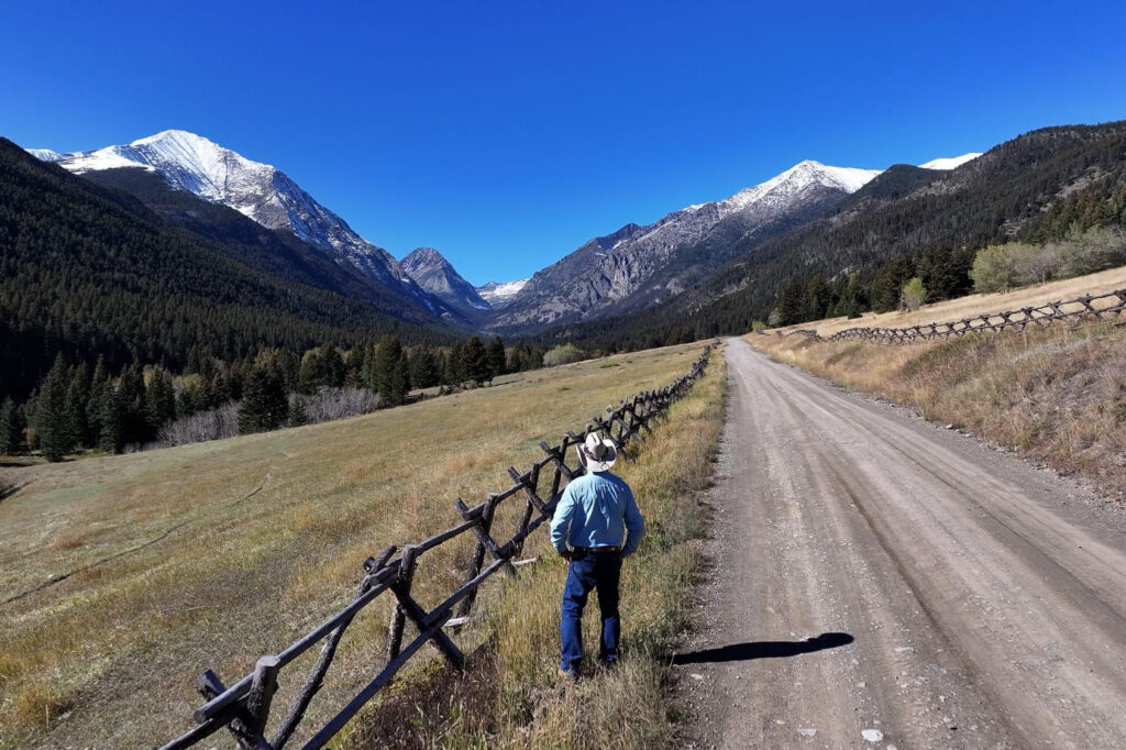 Brad Wilson stands in the lowlands surrounding Big Timber Canyon, the kind of terrain the public forfeited in exchange for higher-elevation areas beyond. “My whole comment would be, we'll give them that and we'll keep this, this beautiful land with timber and wildlife, and we'll give them the mountain goats, ice and snow,” Wilson said. Credit: Evan Simon/Floodlight