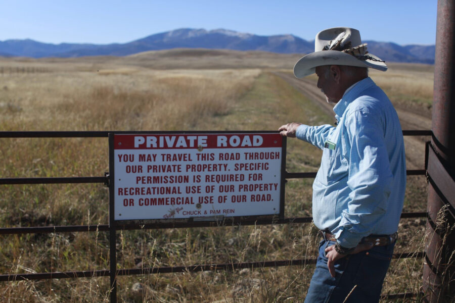 Fifth-generation Montanan Brad Wilson stands beside a dirt road that leads to a century-old public trail that was abandoned by the U.S. Forest Service as part of a controversial land swap with the Yellowstone Club—an exclusive mountaintop retreat for the megarich. Credit: Evan Simon/Floodlight