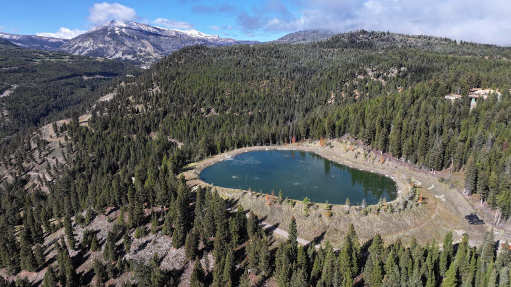 A wastewater pool built by the Yellowstone Club’s owners sits perched high above the headwaters of the Gallatin River. In 2016, a similar wastewater pool leaked more than 30 million gallons of the club's sewage into the river below, drawing over $300,000 in penalties and outraging locals. Credit: Evan Simon/Floodlight