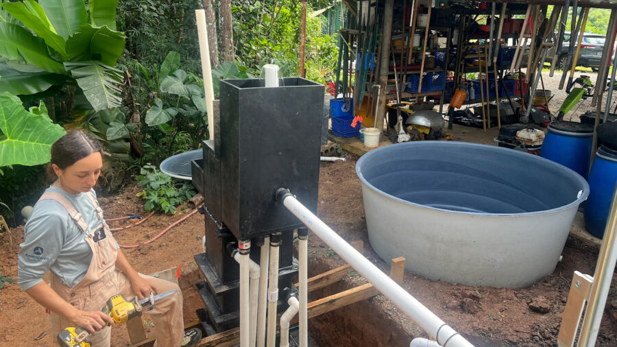 Laura Sofía García Canto, a program manager at Plenitud, works on the water treatment system installation at the nonprofit in Las Marías, Puerto Rico.