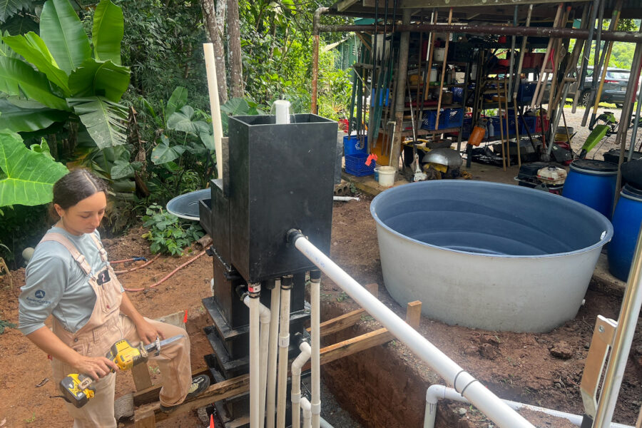 Laura Sofía García Canto, a program manager at Plenitud, works on the water treatment system installation at the nonprofit in Las Marías, Puerto Rico.