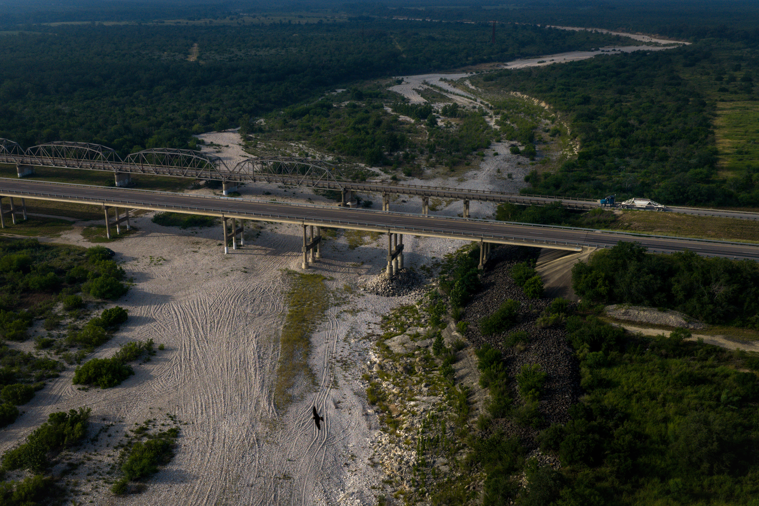 A truck drives over the Nueces River on June 18 near Uvalde. Credit: Jon Shapley/Inside Climate News