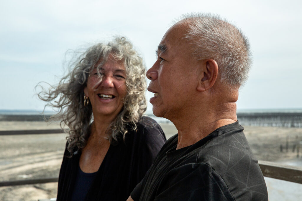 Diane Wilson listens to Lin Chun Lan recount stories of oyster farming at Wu Tiao Gang harbor in Yunlin County, Taiwan.