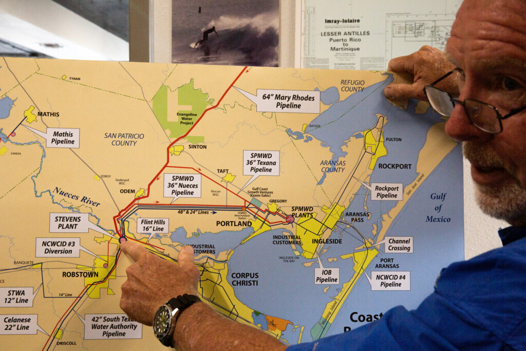 John Michael, vice president of Hanson Professional Services in Corpus Christi, explains a map of Corpus Christi’s water supply and distribution system in his office in May. Credit: Dylan Baddour/Inside Climate News