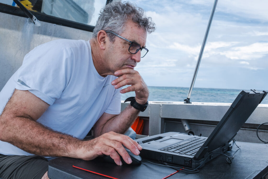 Woods Hole oceanographer Peter Traykovski originally built the robot named Yellowfin to measure coastline erosion. More recently, he adapted the vehicle to survey coral reefs by attaching a GoPro camera to its hull. Credit: Tim Briggs