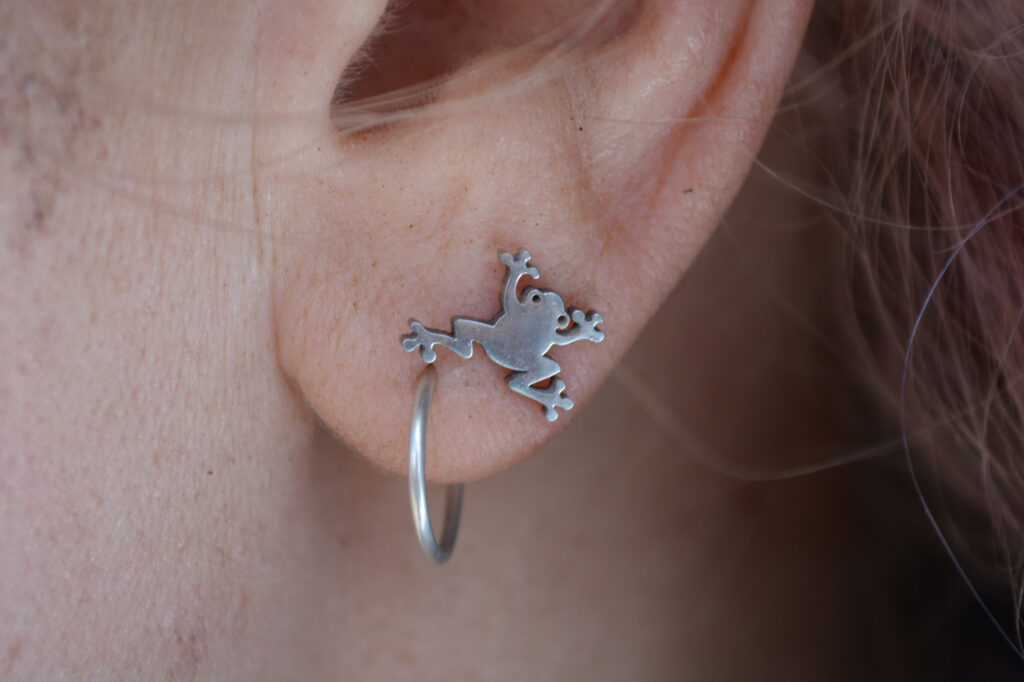 Cozad wears a frog earring while working on the habitat restoration project. Credit: Wyatt Myskow/Inside Climate News