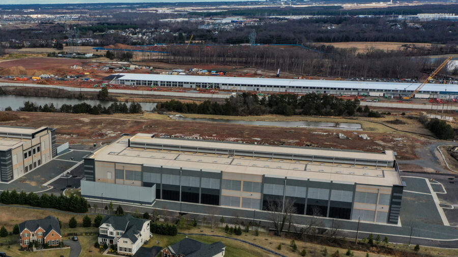 A Microsoft data center is seen under construction behind a recently constructed Amazon data center in Aldie, Va., on Jan. 20, 2023. Credit: Jahi Chikwendiu/The Washington Post via Getty Images