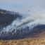 A helicopter crew battles a wildfire near Kalispell, Mont., in August 2022. Credit: Don and Melinda Crawford/Universal Images Group via Getty Images