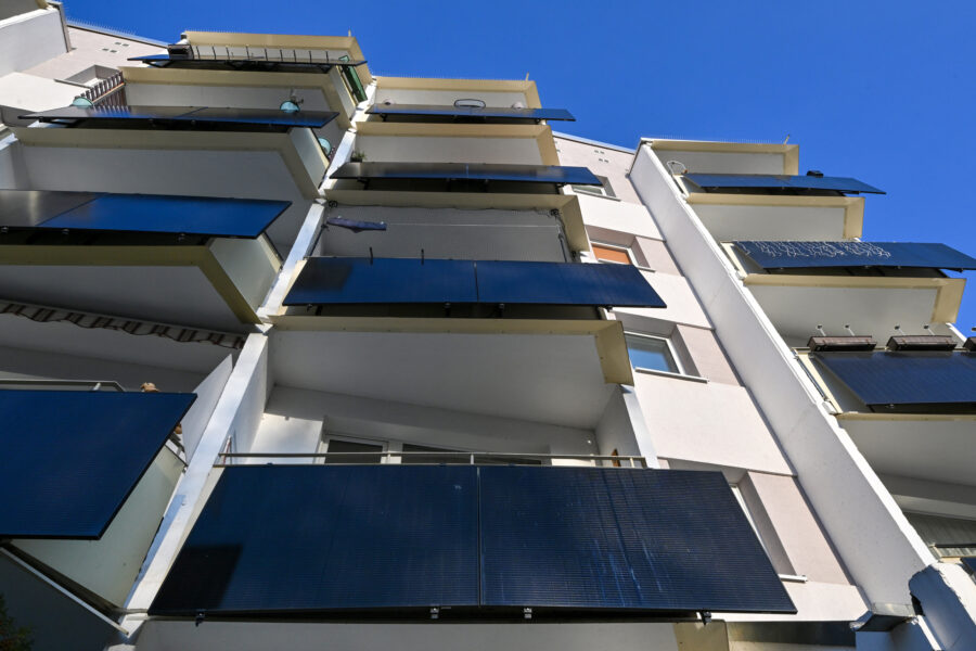 Plug-in solar panels sit on the balconies of a building in Erfurt, Germany. Credit: Martin Schutt/picture alliance via Getty Images