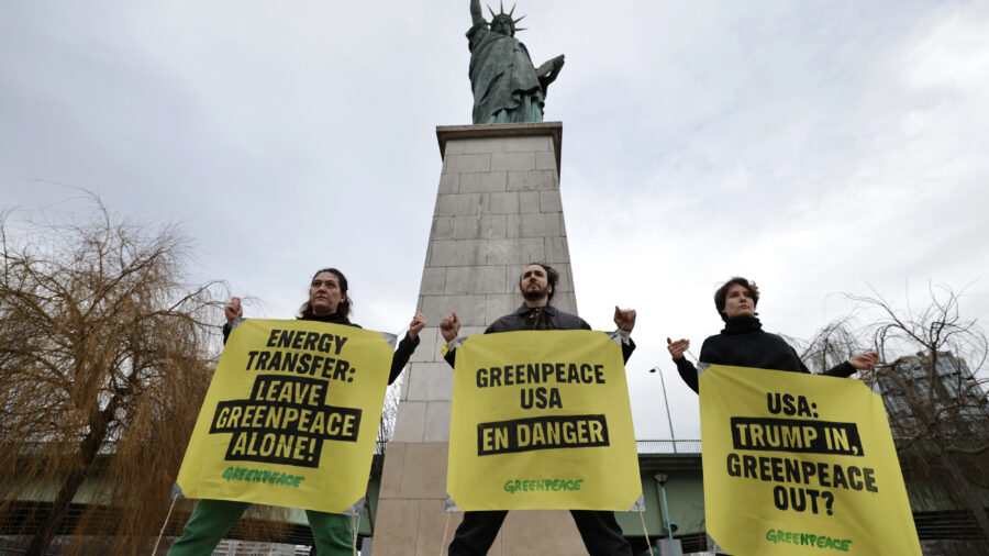 French Greenpeace activists rally to support the environmental group in Energy Transfer’s lawsuit next to the Statue of Liberty at Pont de Grenelle in Paris on Feb. 20, 2025. Credit: Thibaud Moritz/AFP via Getty Images
