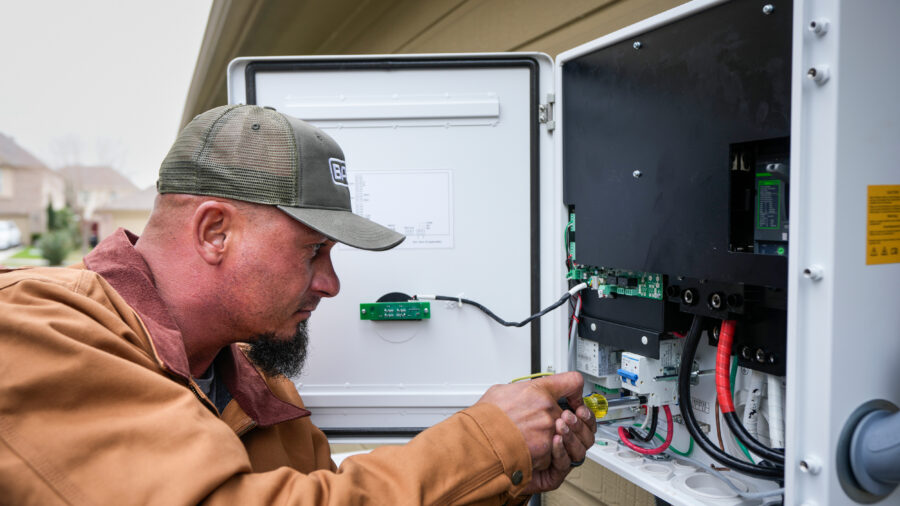 A worker with Base Power installs a home battery system that can send energy back to the grid during peak times in Houston on Feb. 18, 2025. Credit: Brett Coomer/Houston Chronicle via Getty Images