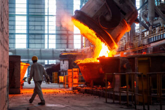 A worker walks past molten steel at a factory in Huai'an, China, on July 22, 2025. Credit: CN-STR/AFP via Getty Images