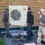 HVAC technicians install a heat pump system at a home in Charlotte, Vt., on July 21, 2025. Credit: Robert Nickelsberg/Getty Images
