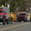 Wildland firefighters stage on Baseline Road in Boulder, Colo., as a helicopter crew works to battle a fire near Chautauqua on Feb. 28. Credit: Matthew Jonas/MediaNews Group/Boulder Daily Camera via Getty Images