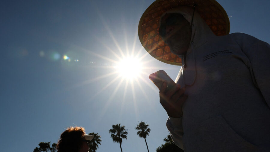 A person wears a hat for shade during a heat wave on March 20 in Redondo Beach, Calif. The March heat wave that blistered the Western U.S. foreshadows more extreme heat this summer, former NOAA climate scientists said in a briefing this week. Credit: Patrick T. Fallon/AFP via Getty Images