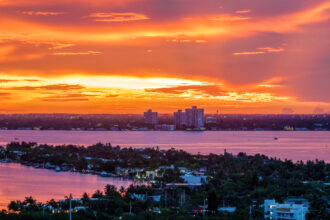 An aerial view over Miami’s Biscayne Bay at sunset. Credit: Jeffrey Greenberg/Universal Images Group via Getty Images