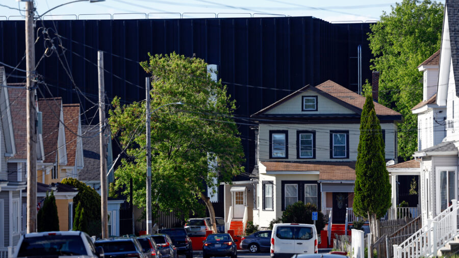 Lowell, MA - May 12: The view down a street in Lowell, Mass., where a data center looms behind residential housing on May 12. Credit: Danielle Parhizkaran/The Boston Globe via Getty Images