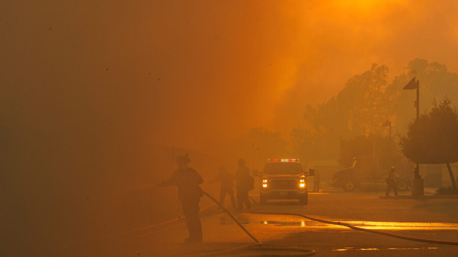 Firefighters are barely visible as smoke from the Bain Fire fills the air on May 19 in Jurupa Valley, Calif. Credit: Gina Ferazzia/Los Angeles Times via Getty Images