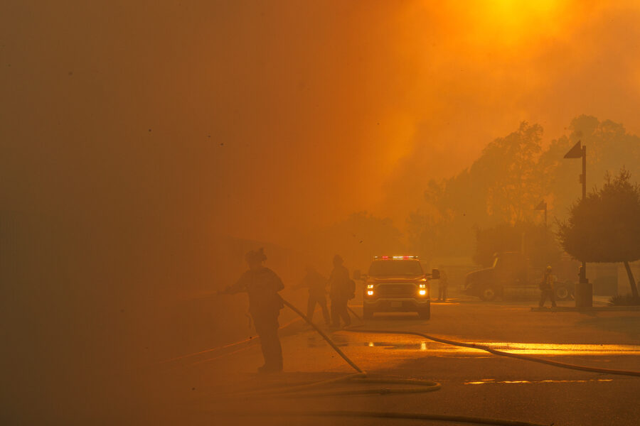 Firefighters are barely visible as smoke from the Bain Fire fills the air on May 19 in Jurupa Valley, Calif. Credit: Gina Ferazzia/Los Angeles Times via Getty Images