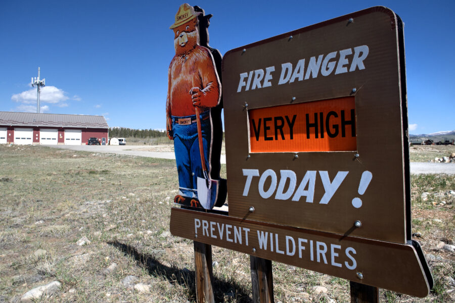 The sign with Smokey Bear says, "Fire danger very high today! Prevent wildfires"