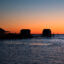 A fisherman passes crab shanties during sunrise Tangier, Va. Credit: Jim Watson/AFP via Getty Images