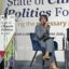 Columbia Mayor Barbara Buffaloe is sitting and speaking into a microphone on the stage, a sign behind and in front of her that says, "State of Climate Politics Forum."