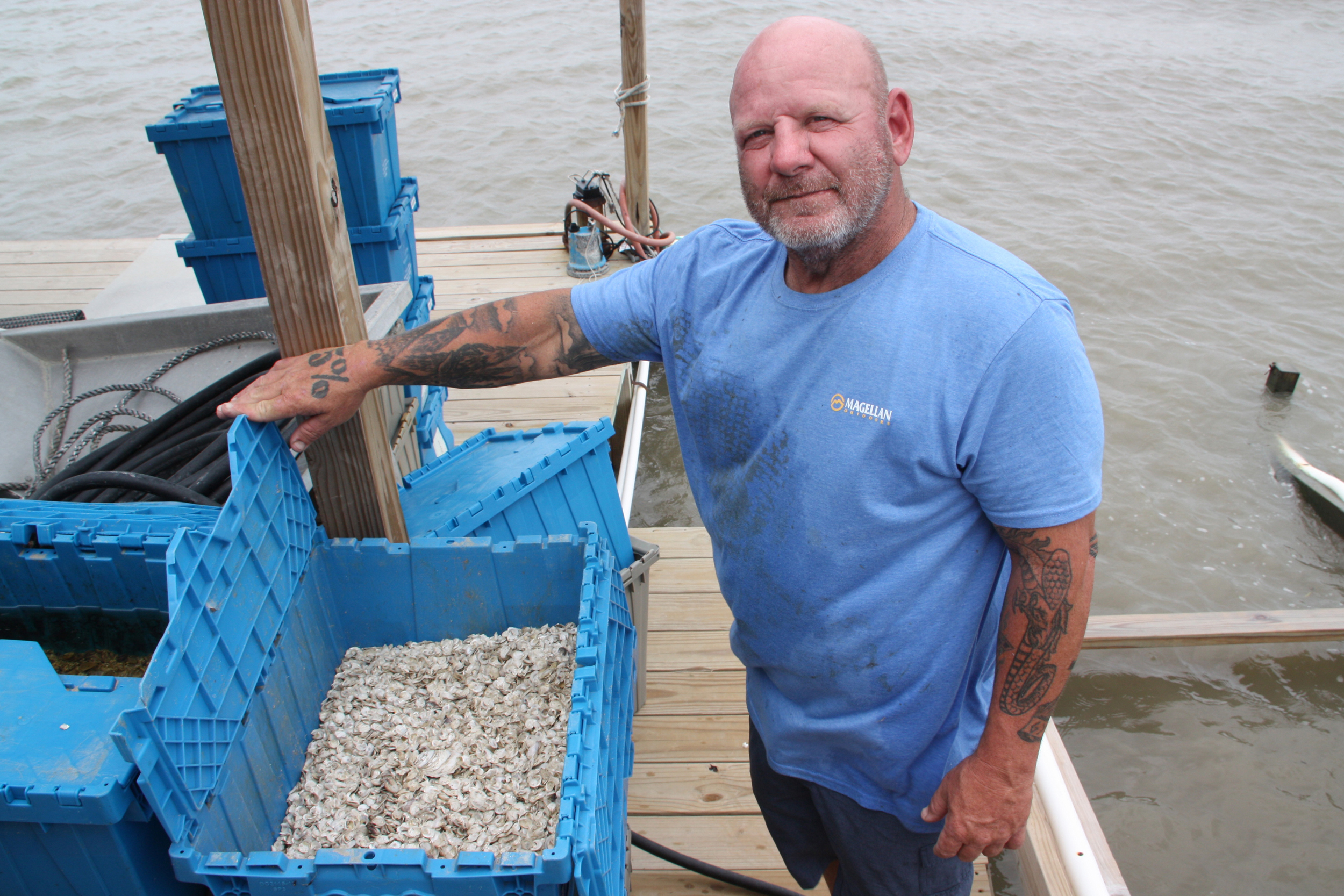 Anthony Theriot displays the shells of oysters that he said were killed after dredging by Venture Global spilled beyond the project’s boundaries. Credit: Nicholas Kusnetz/Inside Climate News