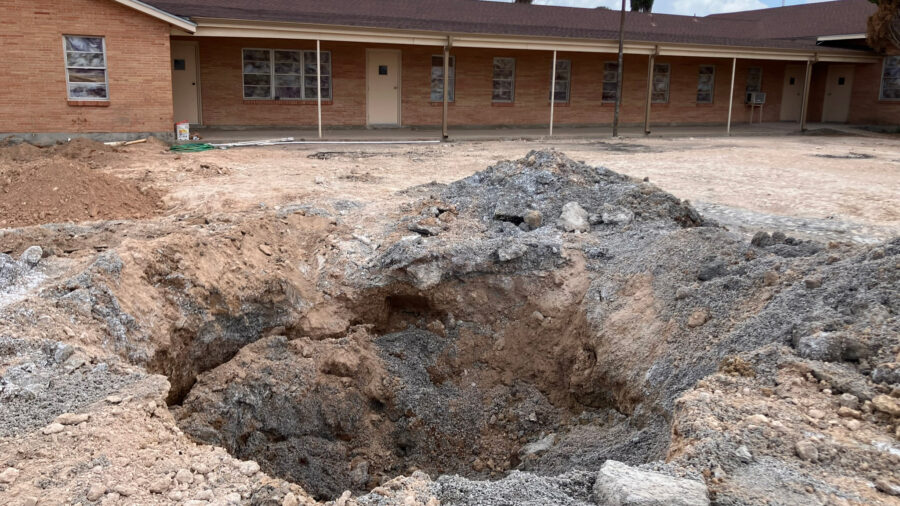 A pit in the parking lot of the First Baptist Church in Grandfalls, Texas, where the Railroad Commission plugged a wellbore that was previously gushing thousands of gallons of wastewater a minute. Credit: Martha Pskowski/Inside Climate News