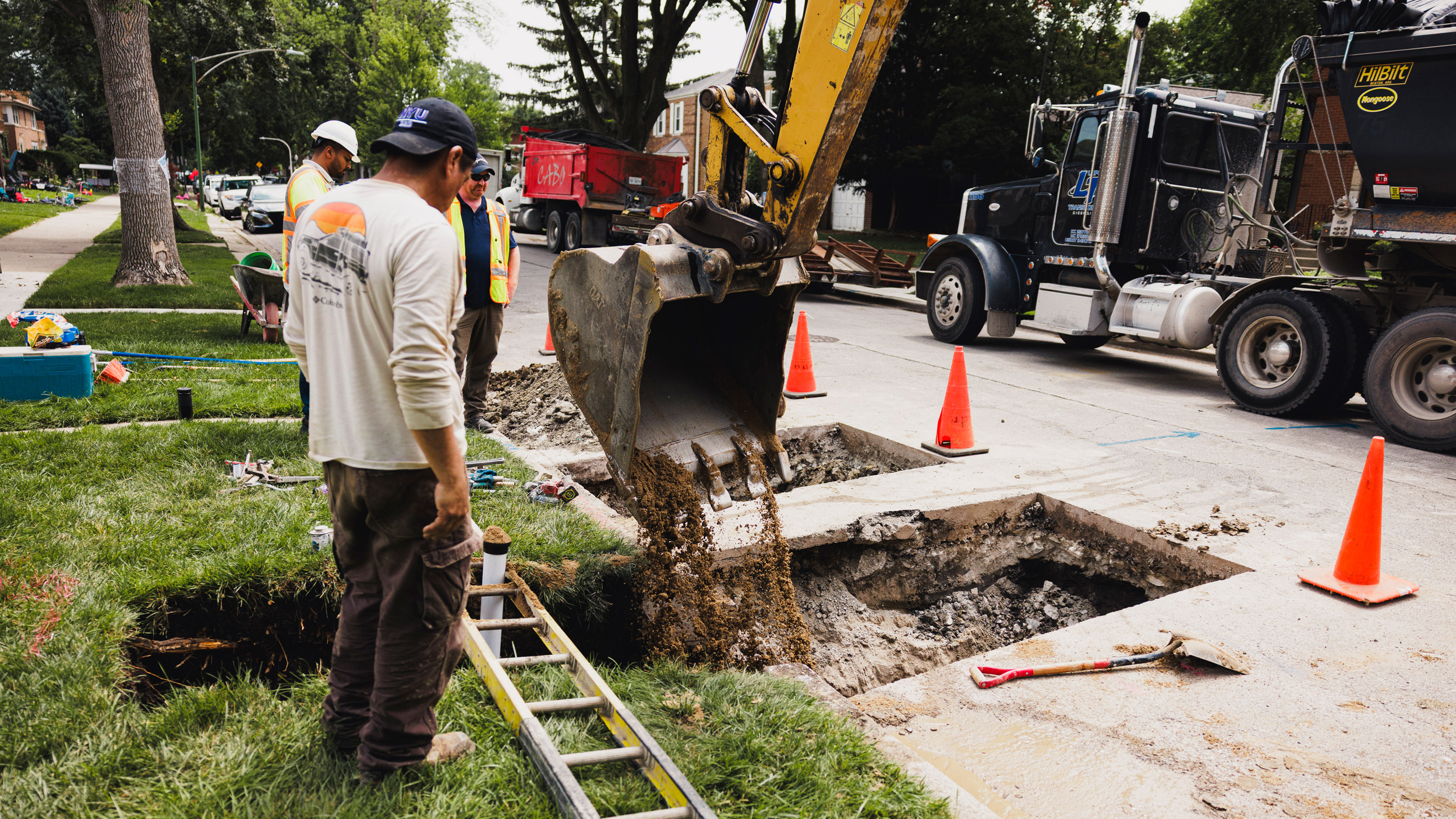 Workers cover piping after replacing a lead pipe with a new water main at a home in West Ridge on July 25, 2025. Credit: Anthony Vazquez/Sun-Times