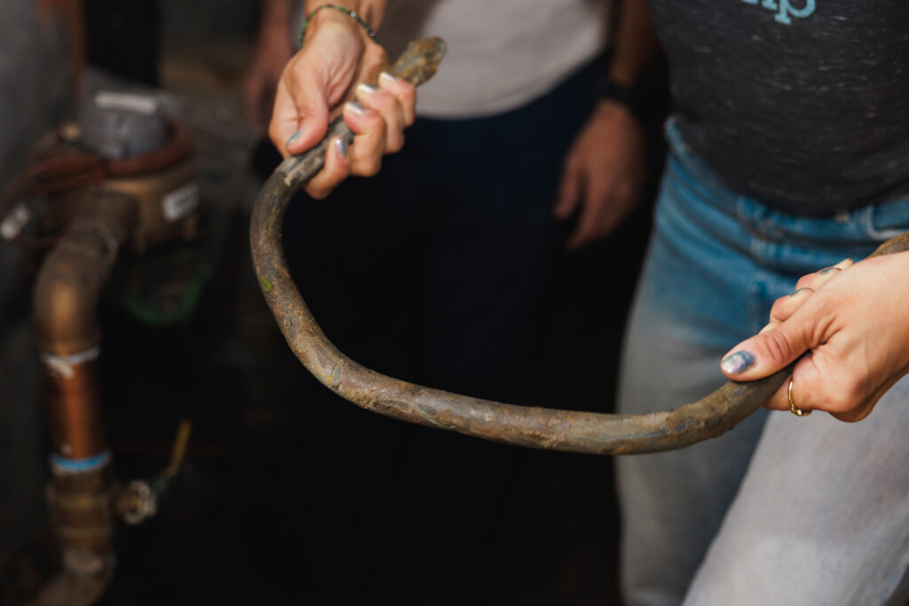Alaina Harkness holds a lead pipe that was replaced at her home in Hyde Park. Credit: Anthony Vazquez/Sun-Times