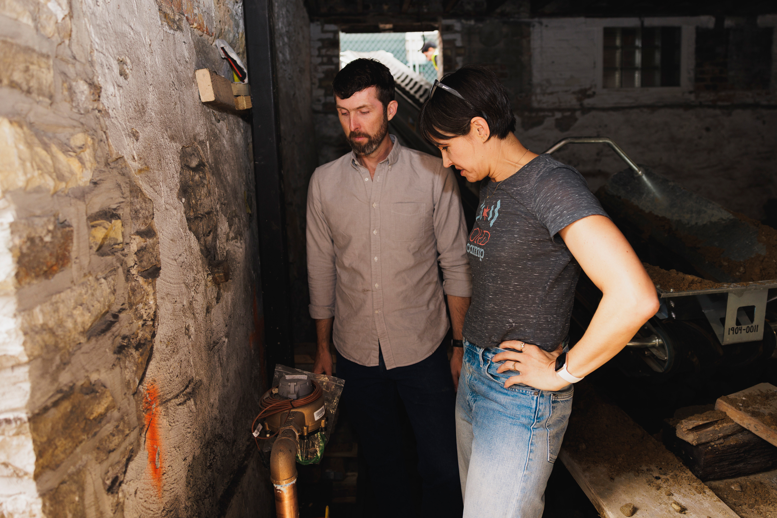 Ryan Wilson (left) and Alaina Harkness stand next to their new water meter that was placed during the replacement of their lead water pipes in their home in Hyde Park. Credit: Anthony Vazquez/Sun-Times