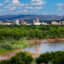 People paddle the Rio Grande with downtown Albuquerque in the background. Credit: City of Albuquerque