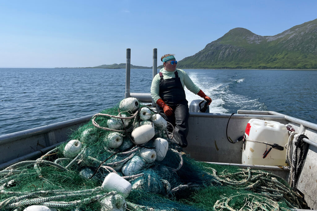 Michelle Stratton, fisheries scientist and executive director of Alaska Marine Community Coalition, moves gear to fishing grounds off Kodiak Island. Credit: Hannah Heimbuch