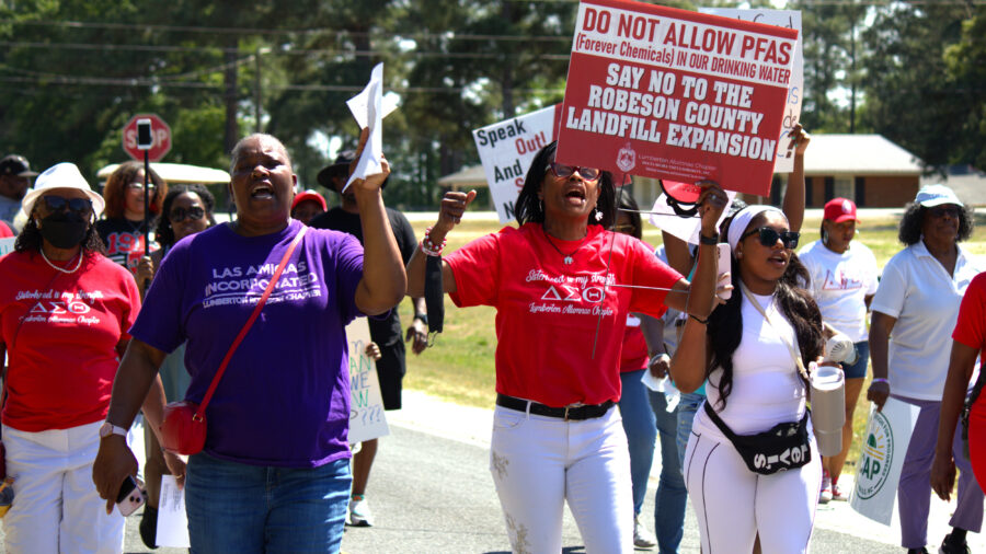 Members of the Lumberton Alumnae Chapter of the Delta Sigma Theta Sorority and Las Amigas Incorporated march along Britt Road on April 18 in St. Pauls, N.C., against the Robeson County Landfill expansion. Credit: Morgan Casey