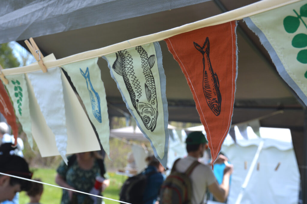 The town of Benton held its annual Alewife Festival to celebrate the fish’s migration. The festival includes fish-themed crafts, education booths and samples of the fish. Credit: Sydney Cromwell/Inside Climate News