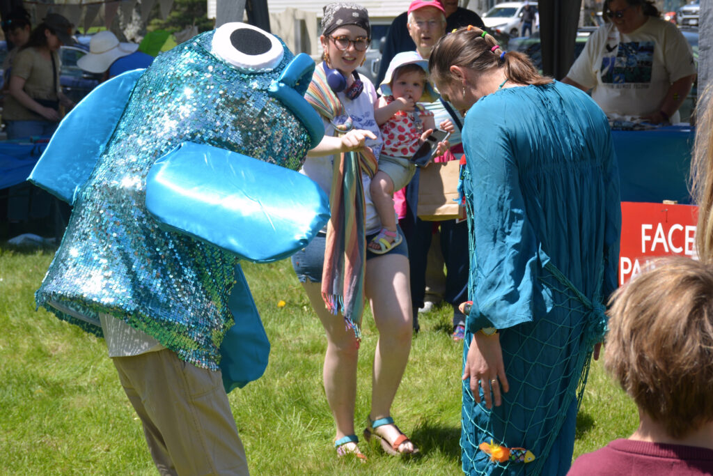 The town of Benton held its annual Alewife Festival to celebrate the fish’s migration. The festival includes fish-themed crafts, education booths and samples of the fish. Credit: Sydney Cromwell/Inside Climate News