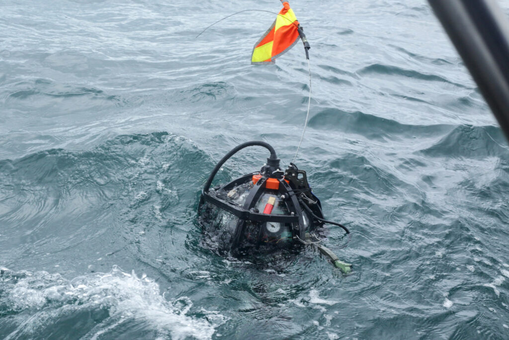 A Deep Sea Camera System from National Geographic’s Exploration Technology Lab resurfaces after capturing footage of the coral reef. Credit: Ghislain Adjahouisso