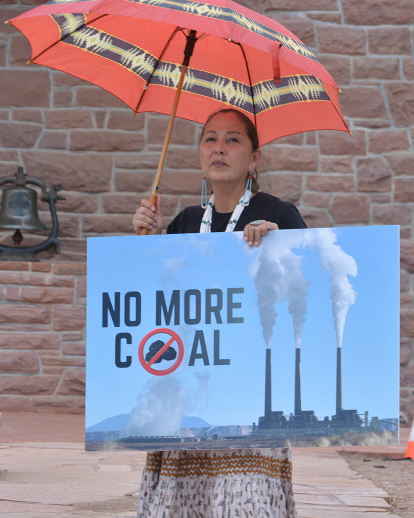 Nicole Horseherder, executive director of Tó Nizhóní Ání, a local Indigenous group focused on protecting the Navajo Nation’s water resources and opposing coal mining, holds a sign reading “No More Coal” at the July 20 press conference at Window Rock, Ariz. Credit: Wyatt Myskow/Inside Climate News