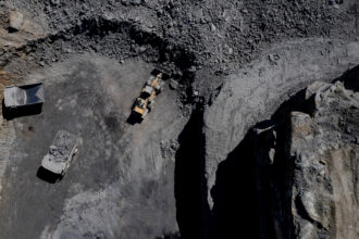 Trucks operate at a coal mine in Lost Creek, Ky. Credit: Diane Desobeau/AFP via Getty Images