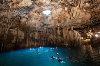 Visitors swim in the water at the Cenote Xkeken near Chichén Itzá in Yucatán, Mexico. Credit: Sebastian Kahnert/dpa via Getty Images