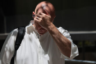 A person wipes sweat off their head during high temperatures and an extreme heat warning in New York City on Thursday. Credit: Michael M. Santiago/Getty Images