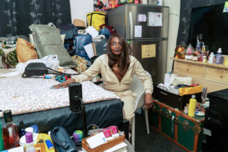 Shirley Jackson sits for a photo in her SRO in San Francisco’s Seneca Hotel on Sixth Street. Jackson is experiencing health problems that are worsened by maintenance issues and pollution in her home. Credit: Neal Wong/San Francisco Public Press