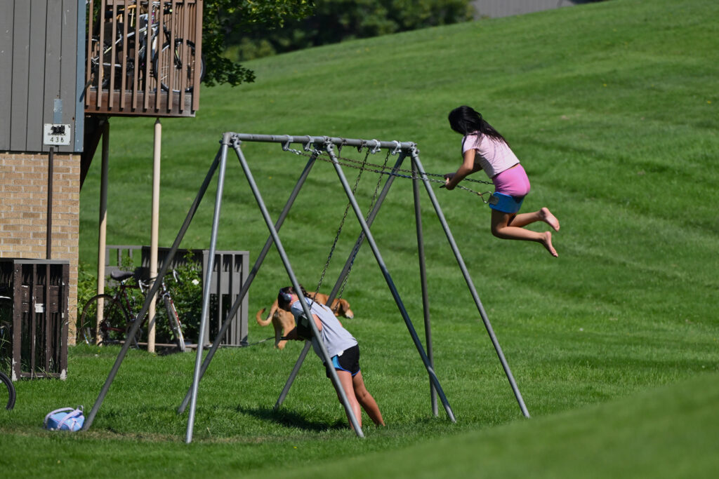 Children play on a swing set in the University Village residential area of Missoula, Mont., on July 15. Credit: Mosabber Hossain/Inside Climate News