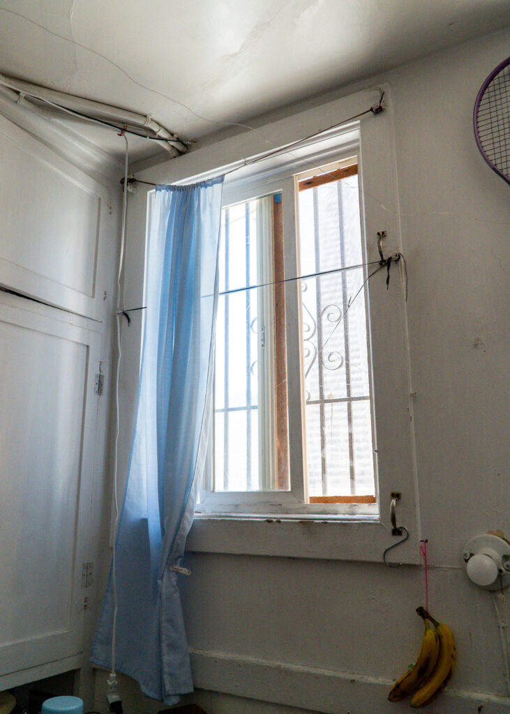 A window in the kitchen area of a family that lives in an SRO unit in Chinatown. Smoke from a nearby restaurant often leaves soot indoors. Credit: Neal Wong/San Francisco Public Press