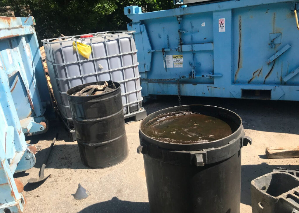 In 2024, state environmental inspectors found petroleum products and trash in open drums outside. Credit: NCDEQ