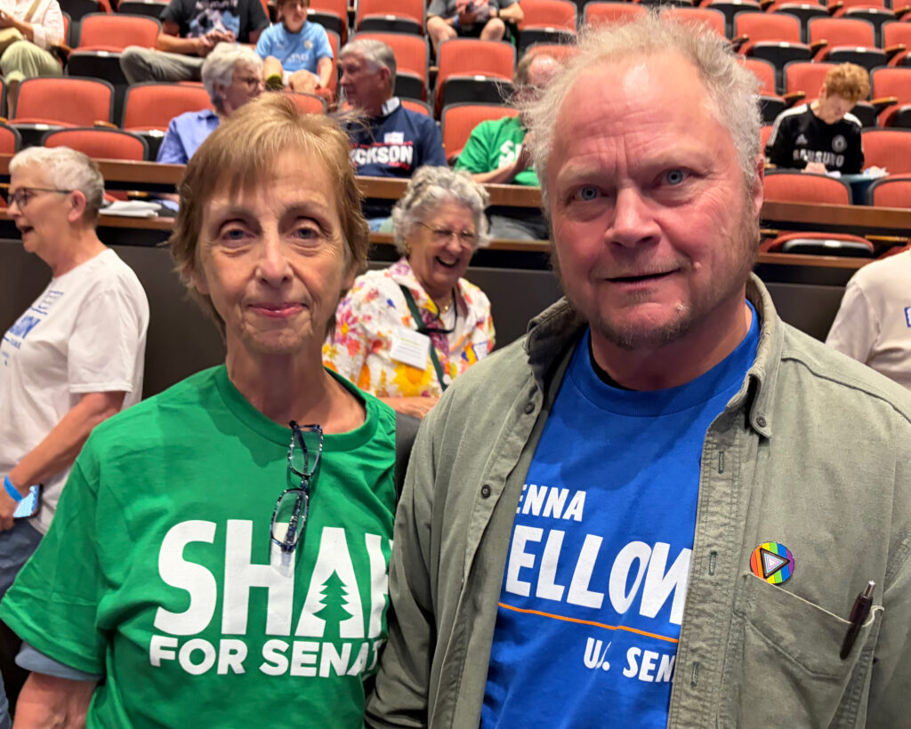 Trish English and Clay Curtis, friends from South Berwick, wear shirts showing their support for candidates Nirav Shah and Shenna Bellows at the York County Democratic Party election of delegates on July 18. Credit: Nathaniel Eisen/Inside Climate News