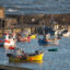 Fishing boats are moored in the harbor on March 2, 2026, in Lyme Regis, England.