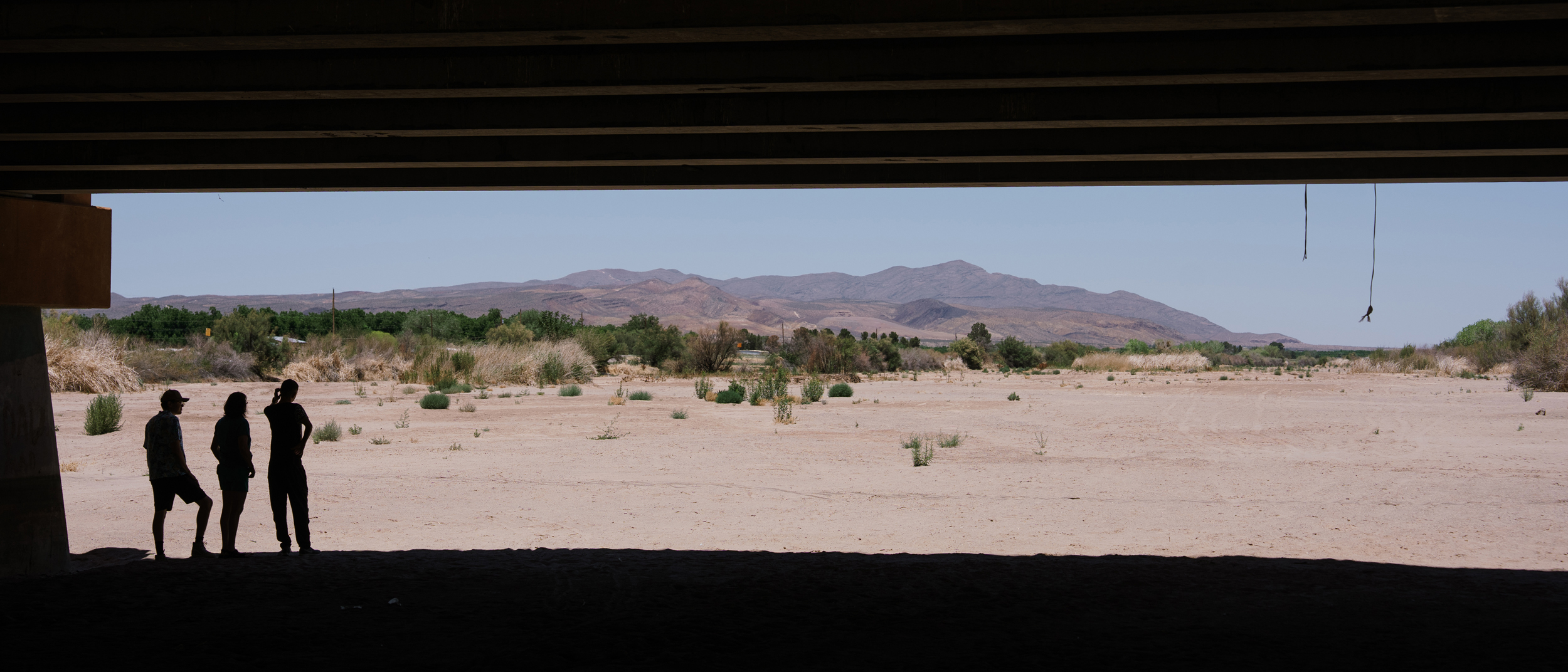 People wait for water to arrive in the dry riverbed of the Rio Grande in Las Cruces on May 30. Elephant Butte, a major reservoir for the Rio Grande, was at low levels after a winter with little snowpack.